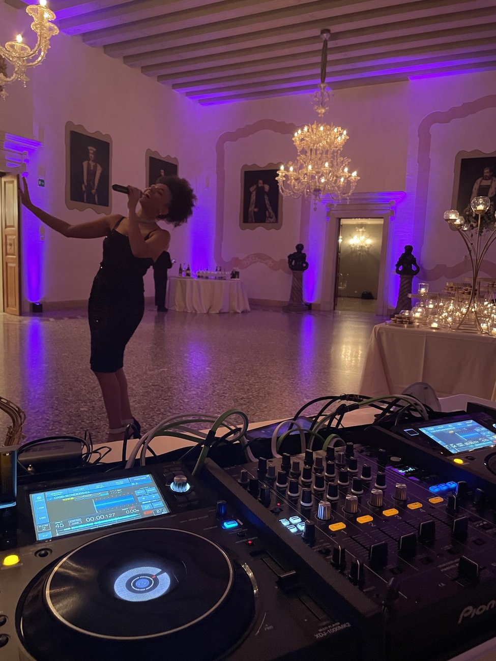 DJ set con cantante dal vivo al Castello di San Salvatore (Susegana, Treviso): la vocalist si esibisce nel salone illuminato di viola accanto alla console Pioneer